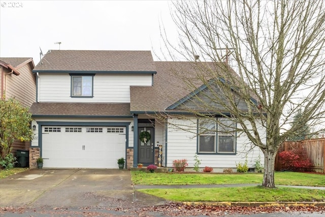 view of front of property featuring a garage and a front yard