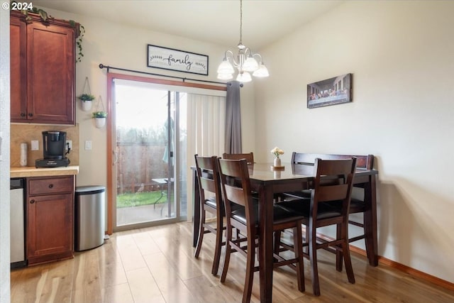 dining area featuring a chandelier and light wood-type flooring