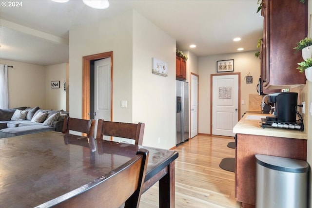 dining space with light hardwood / wood-style flooring and sink