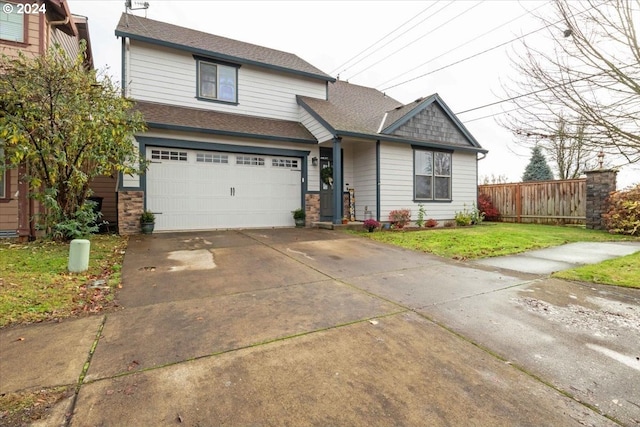 view of front of home featuring a front yard and a garage