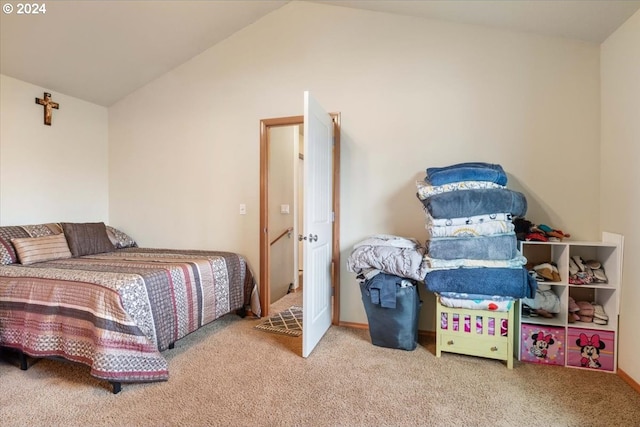 bedroom featuring carpet and lofted ceiling