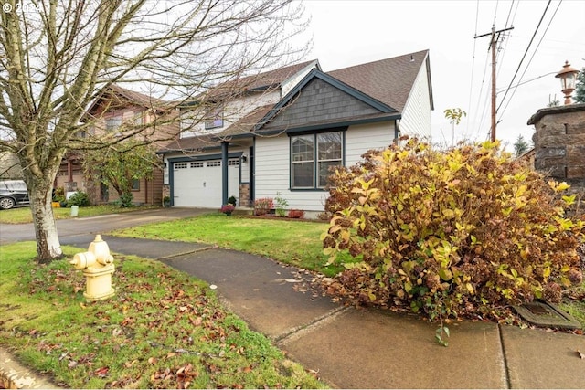 view of front of home with a front yard and a garage