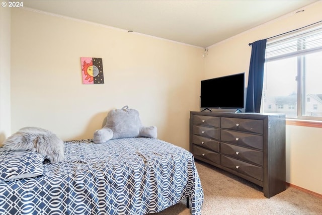 carpeted bedroom featuring crown molding