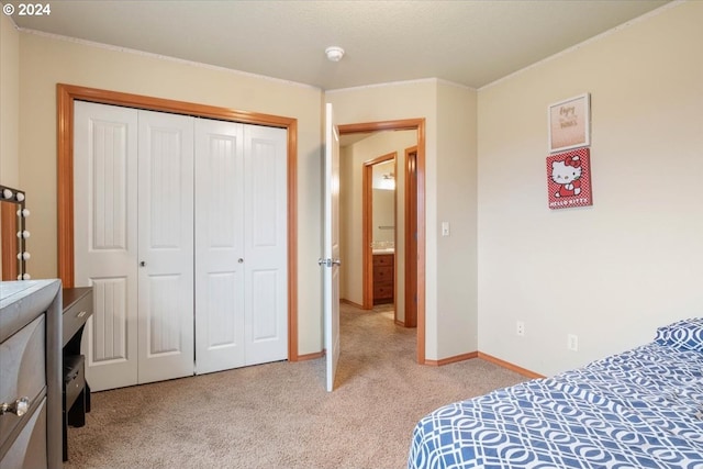 bedroom featuring light colored carpet and a closet