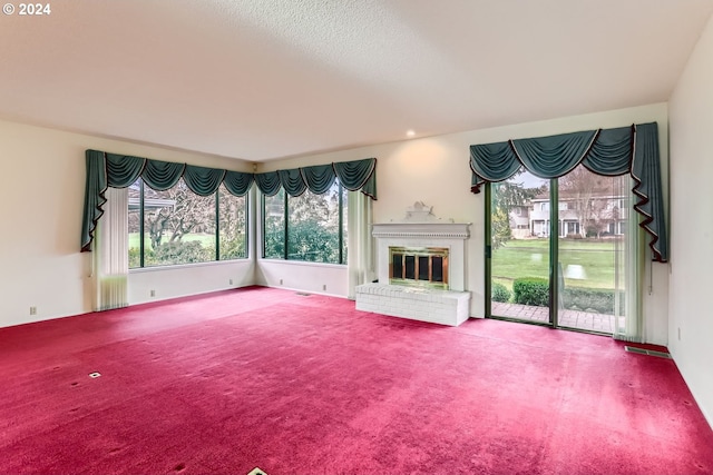 unfurnished living room featuring a fireplace and carpet floors