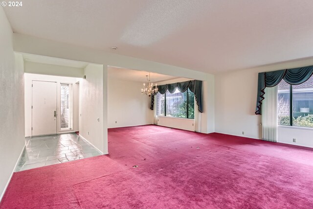 interior space featuring carpet and a notable chandelier