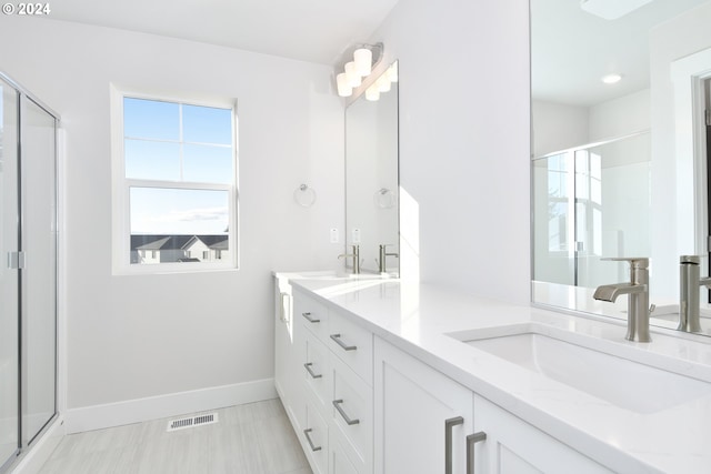 bathroom with vanity and an enclosed shower