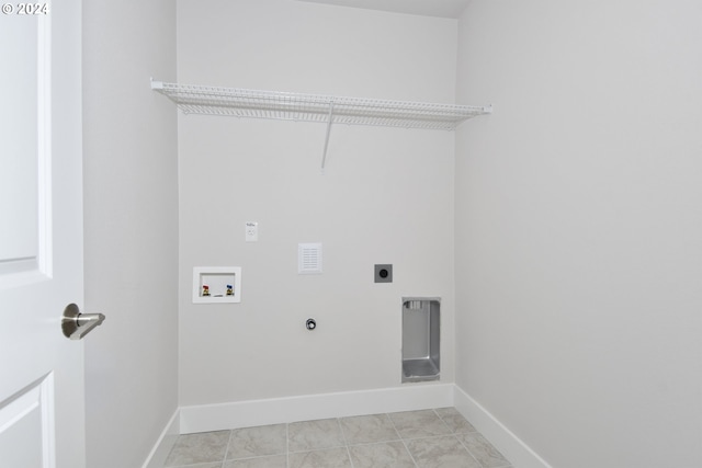 washroom featuring hookup for an electric dryer, washer hookup, and light tile patterned floors