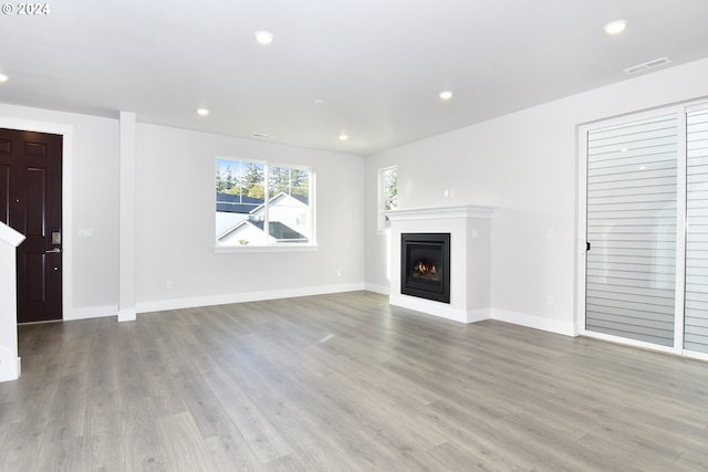 unfurnished living room featuring light hardwood / wood-style floors