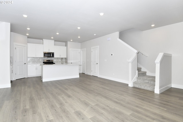 unfurnished living room featuring light hardwood / wood-style flooring