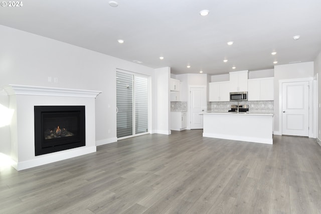 unfurnished living room with light wood-type flooring