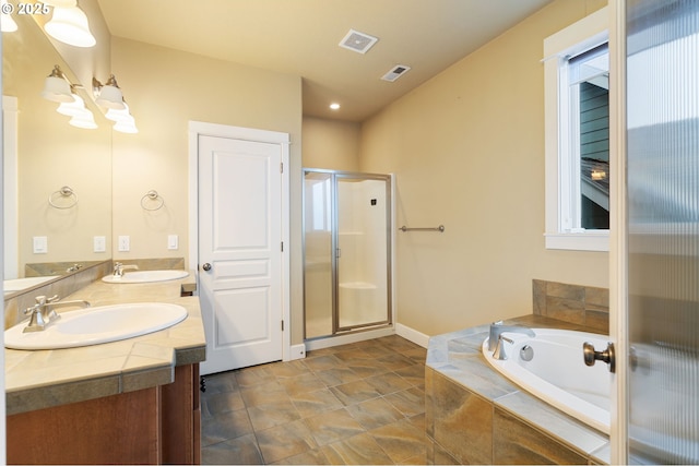 bathroom with vanity and shower with separate bathtub