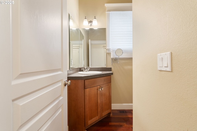 bathroom with vanity and hardwood / wood-style flooring