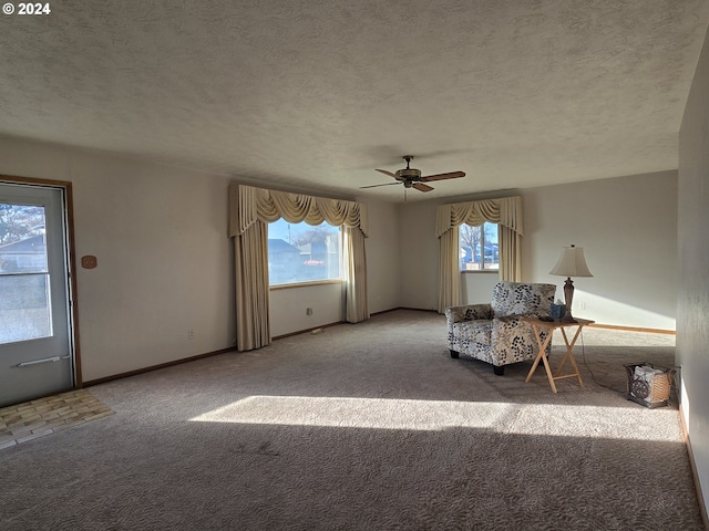 unfurnished room featuring a textured ceiling, carpet floors, and ceiling fan