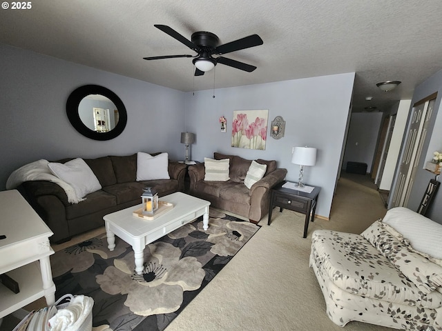 carpeted living room with a textured ceiling and ceiling fan