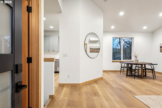 dining area featuring light wood finished floors, baseboards, and recessed lighting