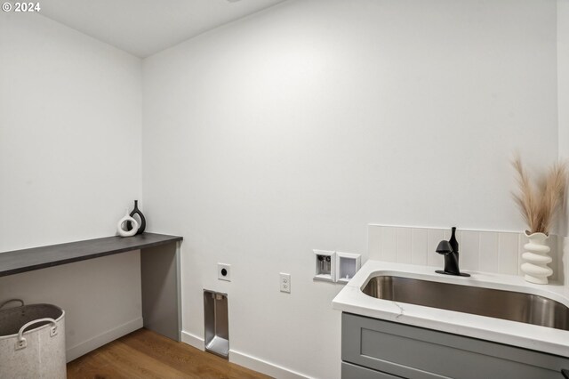 laundry room with hardwood / wood-style flooring, electric dryer hookup, sink, and hookup for a washing machine