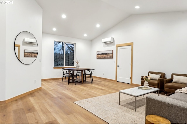 living room featuring an AC wall unit, light hardwood / wood-style floors, and lofted ceiling