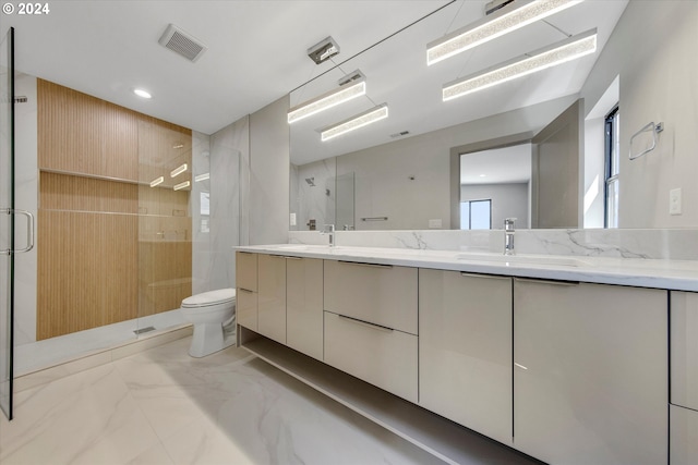 bathroom with vanity, toilet, and a shower with door