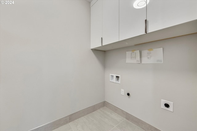 washroom featuring cabinets, hookup for a washing machine, hookup for an electric dryer, and light tile patterned flooring