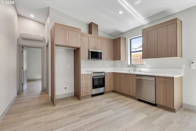 kitchen with a wall mounted air conditioner, light wood-type flooring, stainless steel appliances, vaulted ceiling, and sink