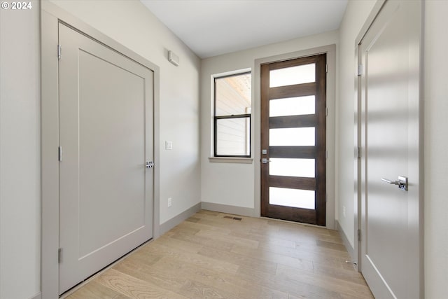 foyer entrance with light wood-type flooring