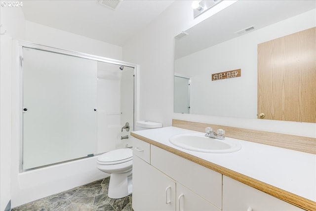 full bathroom featuring enclosed tub / shower combo, vanity, and toilet