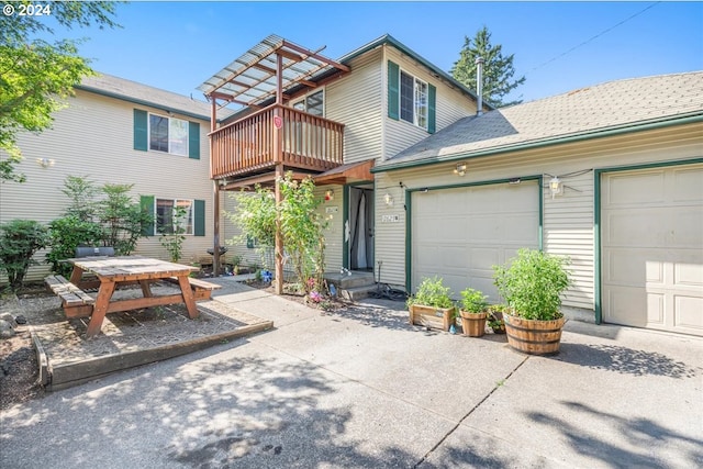 view of front of property featuring a balcony and a garage