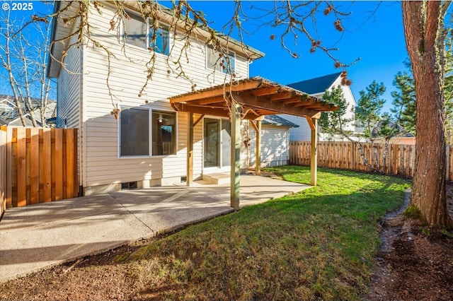 rear view of property with a pergola, a lawn, and a patio