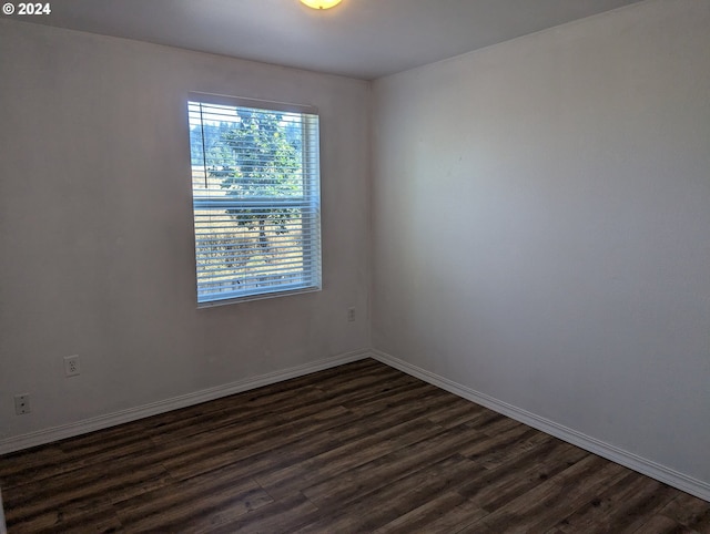 spare room featuring dark hardwood / wood-style flooring