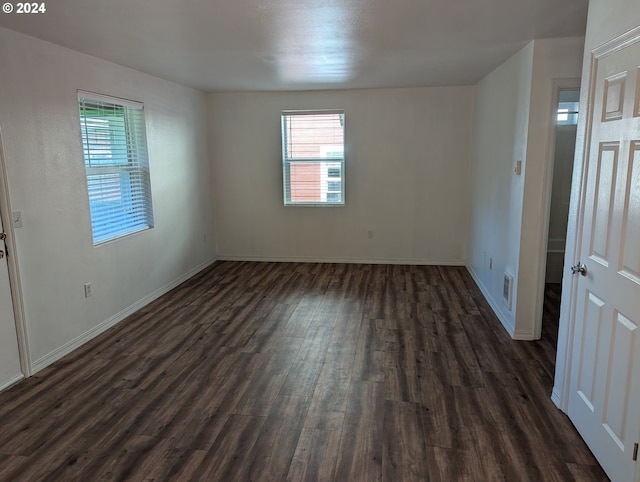 spare room featuring dark wood-type flooring