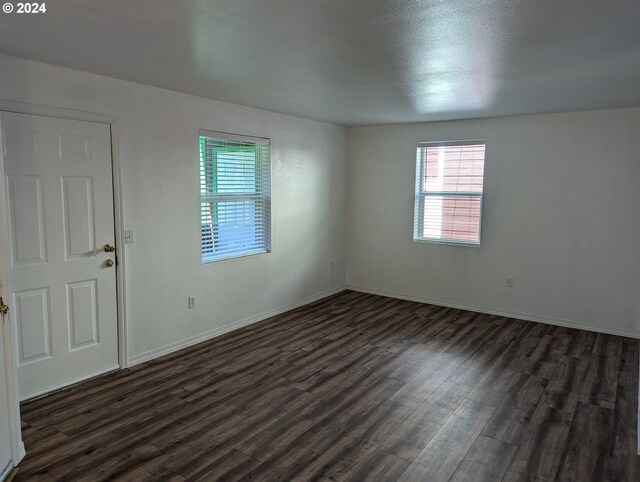 empty room featuring dark hardwood / wood-style floors