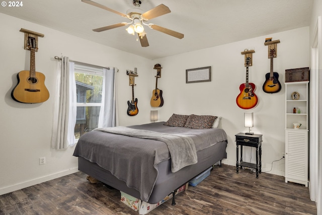 bedroom with ceiling fan and dark hardwood / wood-style flooring