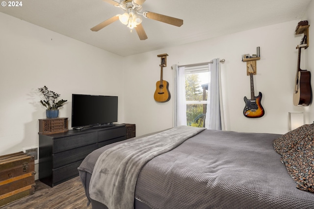 bedroom with ceiling fan and dark wood-type flooring