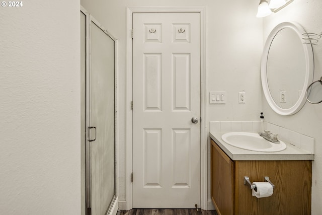 bathroom with vanity, wood-type flooring, and walk in shower