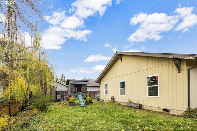 rear view of property with a yard