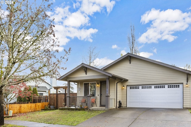 view of front of house with a garage, covered porch, and a front yard