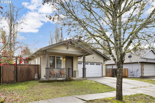 view of front of home with a porch, a garage, and a front lawn