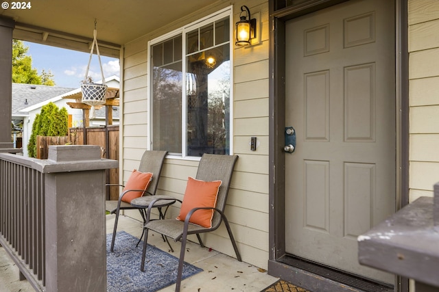 view of exterior entry with a porch