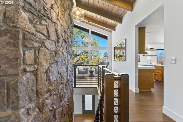 hallway featuring vaulted ceiling with beams, dark hardwood / wood-style flooring, and wood ceiling