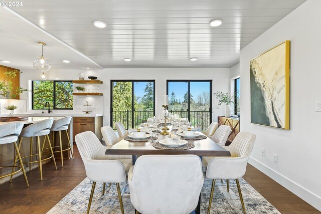 dining room with a wealth of natural light, dark wood-type flooring, and sink