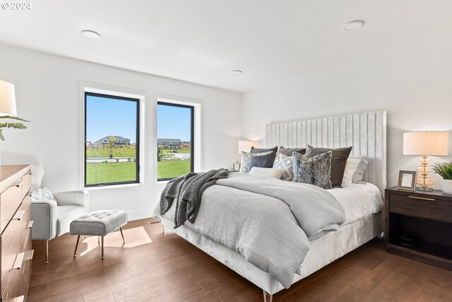 bedroom with dark wood-type flooring