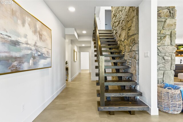 staircase with concrete floors