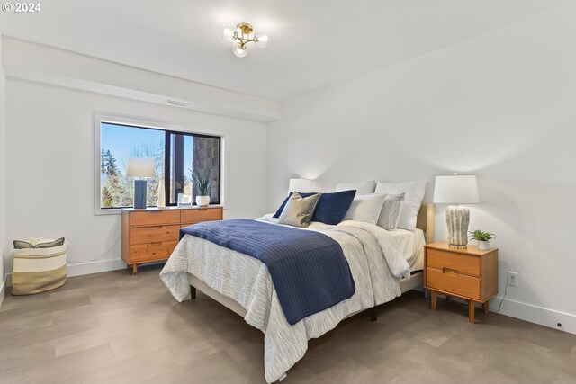 bedroom with hardwood / wood-style flooring