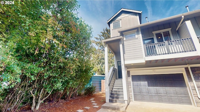 view of front facade featuring a balcony and a garage