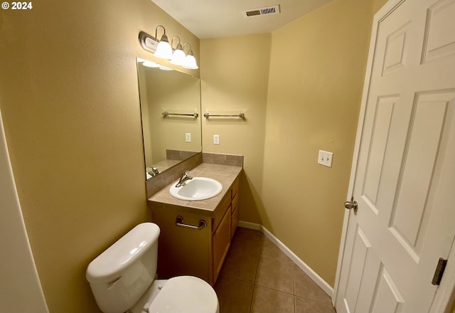 bathroom with tile patterned floors, vanity, and toilet