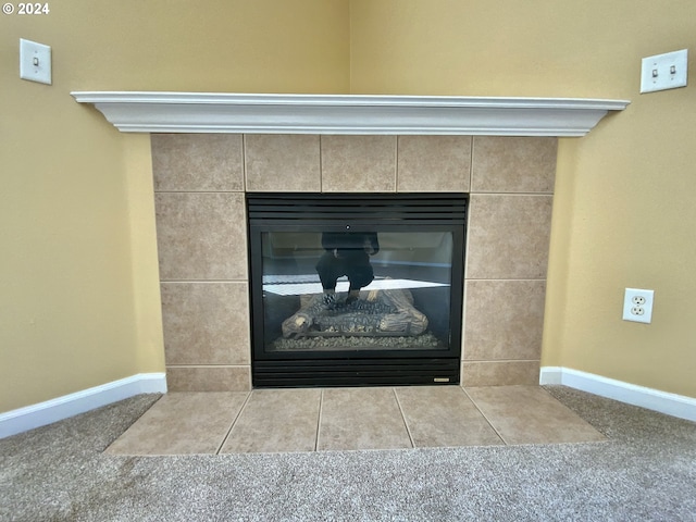 details featuring a tile fireplace and carpet flooring