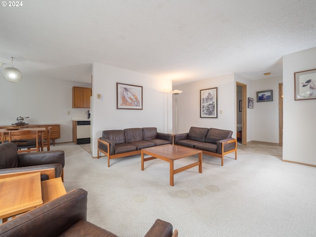 living room featuring light carpet and a textured ceiling