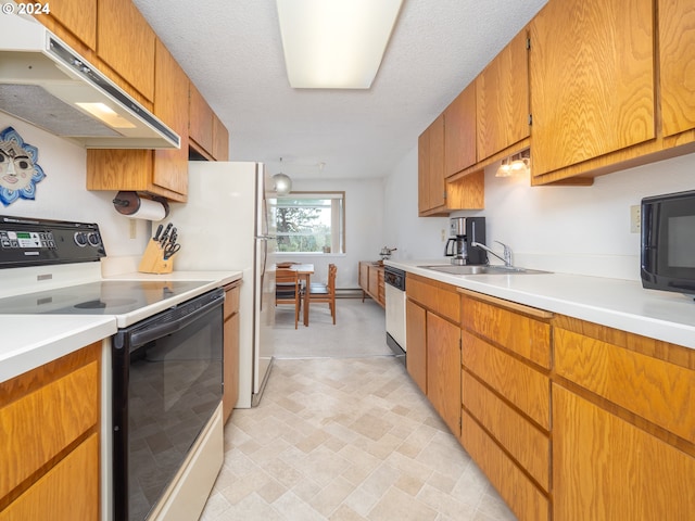 kitchen featuring a textured ceiling, sink, and white appliances