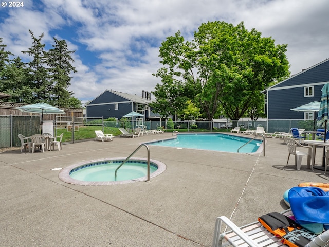 view of pool featuring a community hot tub and a patio area